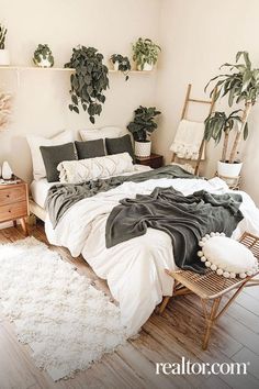 a bedroom with plants on the wall and a bed in the middle, surrounded by white rugs