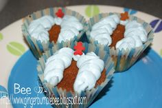 three cupcakes with white frosting and red star on top are sitting on a blue plate