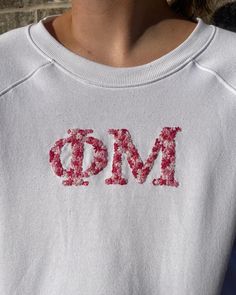 a close up of a person wearing a sweatshirt with the word omd painted on it