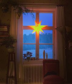 a room with a large star light in the window