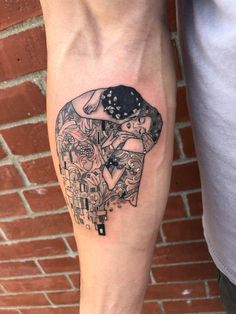 a person with a tattoo on their leg that has an image of a woman holding a baby in her arms