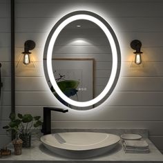 a bathroom with a sink, mirror and lights on the wall next to each other