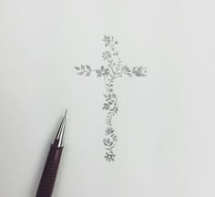 a cross drawn on paper with a pen