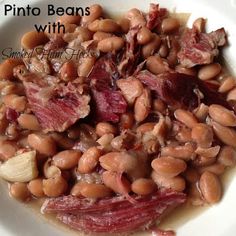 a white plate topped with beans and meat