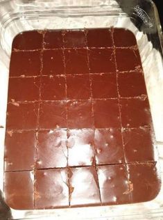 chocolate squares in a baking dish with brown icing on the top and bottom, ready to be baked