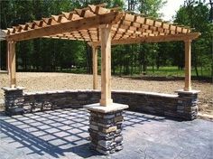 a wooden pergoline sitting on top of a stone patio