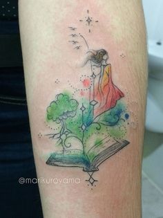 an open book with a drawing of a girl on it's arm and stars above her head