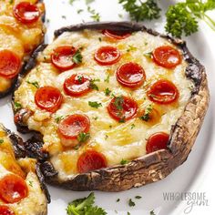 two pizzas with pepperoni and cheese are on a plate next to parsley