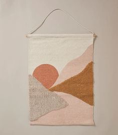 a wall hanging with an abstract painting on it's side and a string attached to the back