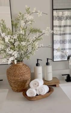 a bathroom with white flowers and towels on the counter