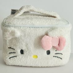 a white hello kitty purse with a pink bow