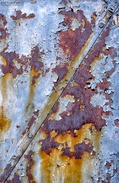 an old rusted metal surface with peeling paint