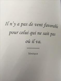 an open book with a black and white quote on the page, in french language