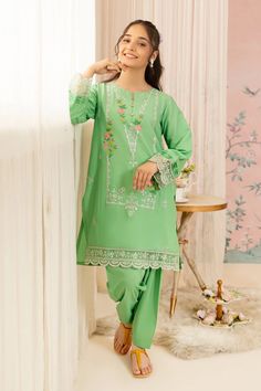 For a chic festive look style our aqua green embroidered shirt featuring a round neckline. Includes: Shirt Only Shalwar Color: Aqua Green Fabric: Cotton Lawn Details: Embroidered Cotton Lawn shirt, Round neckline buttons. Size & Fit: Model Age: 14 Years Model Wears Size: 13/14 Years Designer Green Kurta For Spring, Green Floral Embroidered Kurta For Eid, Eid Kurta With Floral Embroidery In Green, Green Floral Embroidery Kurta For Eid, Spring Green Traditional Wear With Dupatta, Designer Spring Green Salwar Kameez, Green Kurta With Zari Work For Spring, Spring Green Kurta With Zari Work, Green Long Sleeve Traditional Wear For Eid