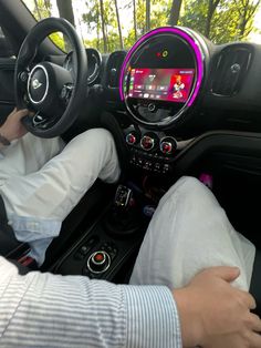 a person sitting in the driver's seat of a car with their feet on the steering wheel