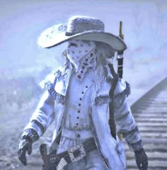 a man dressed in white walking down train tracks with a hat on his head and holding a cane