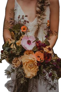 a woman holding a bouquet of flowers in her hands