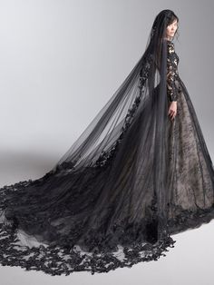 a woman in a black wedding dress with long veil