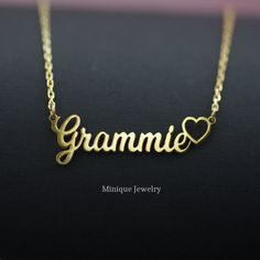 "The dainty Grandma Script Necklace features the word \"Grammie\" and comes with a heart.  It sits beautifully on the neckline and looks stunning, alone or layered. Dainty Grandma Charm in Minimalist Script Font has an inch extension length of 14 to 18 inches. Dimensions: 9.5 mm Capital G,  3.8 mm lower case letters. The overall length of Grammie is 30.5 mm (1  1/4 inches)" Dainty Custom Name Necklace For Mother's Day, Dainty Name Necklace With Hallmarks For Mother's Day, Grandma Name Necklace, Yellow Gold Name Necklace, Gift For Mom, Mimi Necklace, Nana Necklace, Grandma Names, Script Necklace, Grandma Necklace