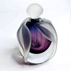 a purple and white bottle sitting on top of a table