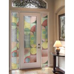 a glass door with an artistic design on it and a lamp next to the door