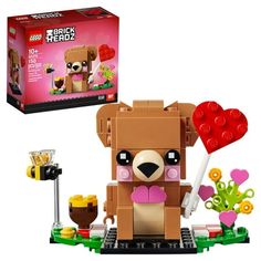 the lego dog is holding a heart shaped lollipop in it's paws