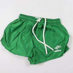 green shorts with white drawstrings on the bottom and logo on the side