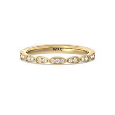 a yellow gold wedding band with white diamonds