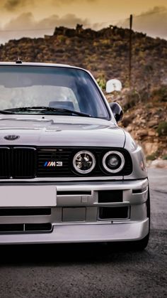 the front end of a silver bmw car