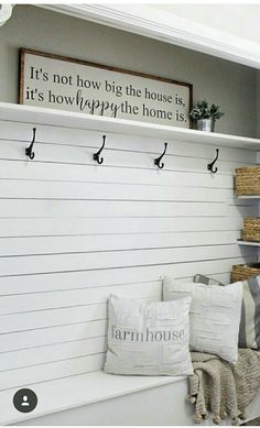 a white bench with some pillows on top of it and a sign above the bench that says pinkibboncottage