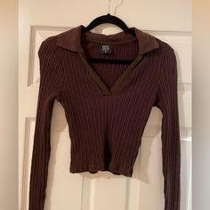 Radically Redefine The Polo Look In This Cropped Rib Style With Long Sleeves And A Deep V-Neckline. Plum Chocolate Color Exclusive Retailer 19" Length (Size Medium) V-Neck Johnny Collar Long Sleeves 98% Cotton, 2% Elastane Machine Wash, Line Dry Made In Turkey Women's Clothing Excellent Condition, Never Worn! Long Sleeve Cropped Sweater, Brown V-neck Crop Top For Fall, Fitted Brown V-neck Crop Top, Urban Outfitters V-neck Crop Top, Brown V-neck Crop Top, Trendy V-neck Tops From Urban Outfitters, Cotton V-neck Crop Top For Night Out, Trendy Brown V-neck Top, Urban Outfitters Long Sleeve Tops For Night Out