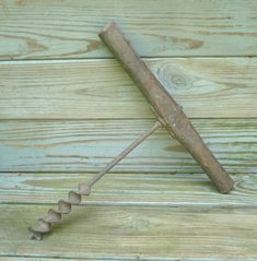 an old rusty metal tool sitting on top of a wooden floor