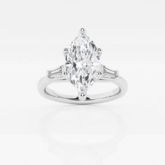 a white gold ring with an oval cut diamond and baguetts on the side