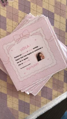 two folded pink cards with an image of a woman's face on them and the words viola written in cursive writing