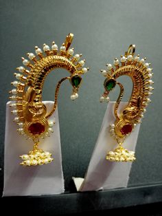 Type : Long Jhumki Earrings || Material : Alloy ||  Colour : Red Green Gold || Plating : Gold Plated || Finish : Glossy & Matte Size : Free Size || Package Contains : 1 Earring Pair | Handmade Indian Jewelry item* Maharashtrian Traditional look Bugdi Clip On Pressing Type earrings for women. They are studded with sparkling stones with pearl beads. Easy to use and comforatble to hold as they are clip-on for Upper Ear It will be more graceful if you wear it with Nauvari paithani , kanjivaram , Maheshwari or Chanderi silk saree. IDEAL GIFTS FOR WOMEN - Come in an elegant jewelry Pouch perfect for any gift giving occasion. Great gifts for women, gifts for girlfriend, gifts for mom, gifts for mother in law, gifts for wife, gifts for daughter, gifts for granddaughter, gifts for aunt, gifts for b Festive Temple Jewelry Single Earring, Chandbali Peacock Earrings For Puja, Peacock Design Chandbali Earrings For Puja, Gold Earrings With Peacock Design For Puja, Peacock Design Earrings For Puja Festivals, Elegant Peacock Design Earrings For Puja, Festival Peacock Design Earrings For Puja, Traditional Single Earring For Ceremonial Occasions, Ceremonial Chandbali Earrings With Peacock Design