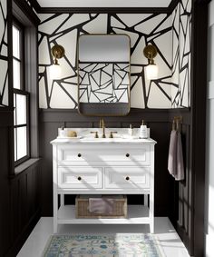 a white sink sitting under a bathroom mirror next to a rug on top of a floor