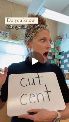 a woman holding a sign with the words cut centt written on it in front of her face