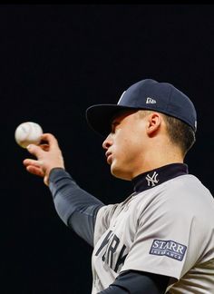 a baseball player holding a ball in his right hand