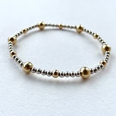 - 3mm Sterling Silver beaded bracelet with 5mm Gold Filled accent beads - Minimal womens stretch bracelet designed to stack and layer to create a unique look - Available in a range of sizes - Gift ready eco packaging Dainty Silver Stretch Bracelet, Dainty Silver Hypoallergenic Stretch Bracelet, Minimalist Silver Hypoallergenic Stretch Bracelet, Silver Hypoallergenic Minimalist Stretch Bracelet, Minimalist Hand-strung Stretch Bracelet For Everyday, Minimalist Hypoallergenic Silver Stretch Bracelet, Classic Silver Beads Stretch Bracelet For Everyday, Elegant Everyday Stretch Bracelet With Silver Beads, Dainty Silver Stackable Stretch Bracelet