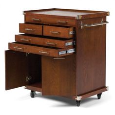 a wooden cabinet with three drawers and two towels on it's casteor wheels