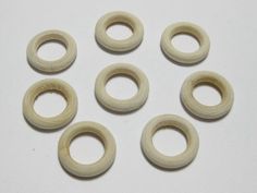 six wooden rings sitting on top of a white table