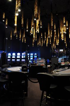 a casino room filled with lots of tables and chairs