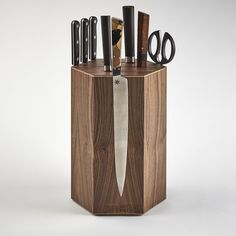 a knife holder with knives and scissors in it