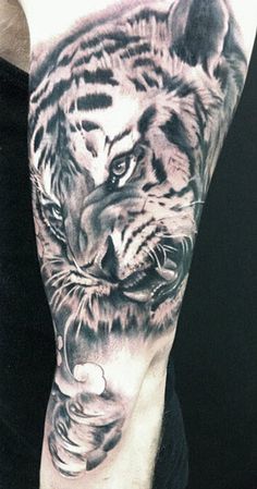 a man with a tiger tattoo on his arm