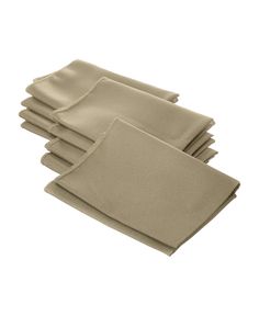 six folded beige napkins sitting on top of each other