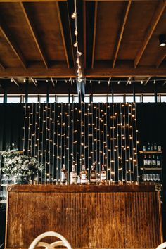 the bar is decorated with lights and bottles