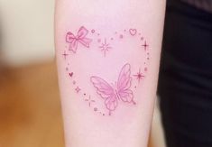 a small pink butterfly tattoo on the right arm and lower arm, with stars in the shape of a heart