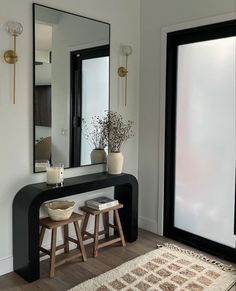 a mirror, stools and table in a room