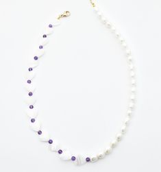 A subtle pop of color on your pearl necklace, this Amethyst studded necklace will have your heart. Alternating Pearl hearts, Amethyst beads, and freshwater pearls will quickly become the best feature of any outfit. White Pearl Heart-shaped Beaded Necklaces, White Pearl Heart-shaped Beaded Necklace, White Heart-shaped Pearl Beaded Necklace, White Beaded Heart-shaped Pearl Necklace, Purple Pearl Single Strand Jewelry, Purple Pearl Single Strand Necklace, Purple Single Strand Pearl Jewelry, Elegant Pearl Necklace With Heart Shaped Beads, White Beaded Amethyst Jewelry