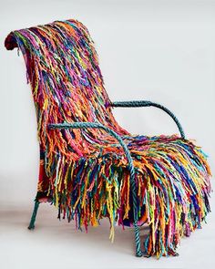 a chair made out of multicolored yarn